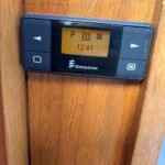 Eberspächer EasyStart diesel heating timer mounted on the wooden interior panel of narrowboat Rasmunda.