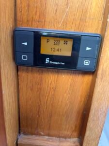 Eberspächer EasyStart diesel heating timer mounted on the wooden interior panel of narrowboat Rasmunda.