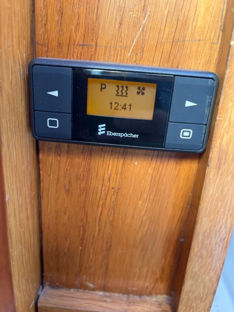 Eberspächer EasyStart diesel heating timer mounted on the wooden interior panel of narrowboat Rasmunda.